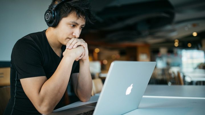 Student studying online on a laptop while planning university costs